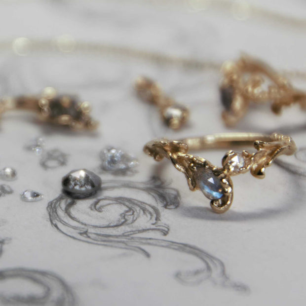 Gold ring with gemstone on a decorative surface